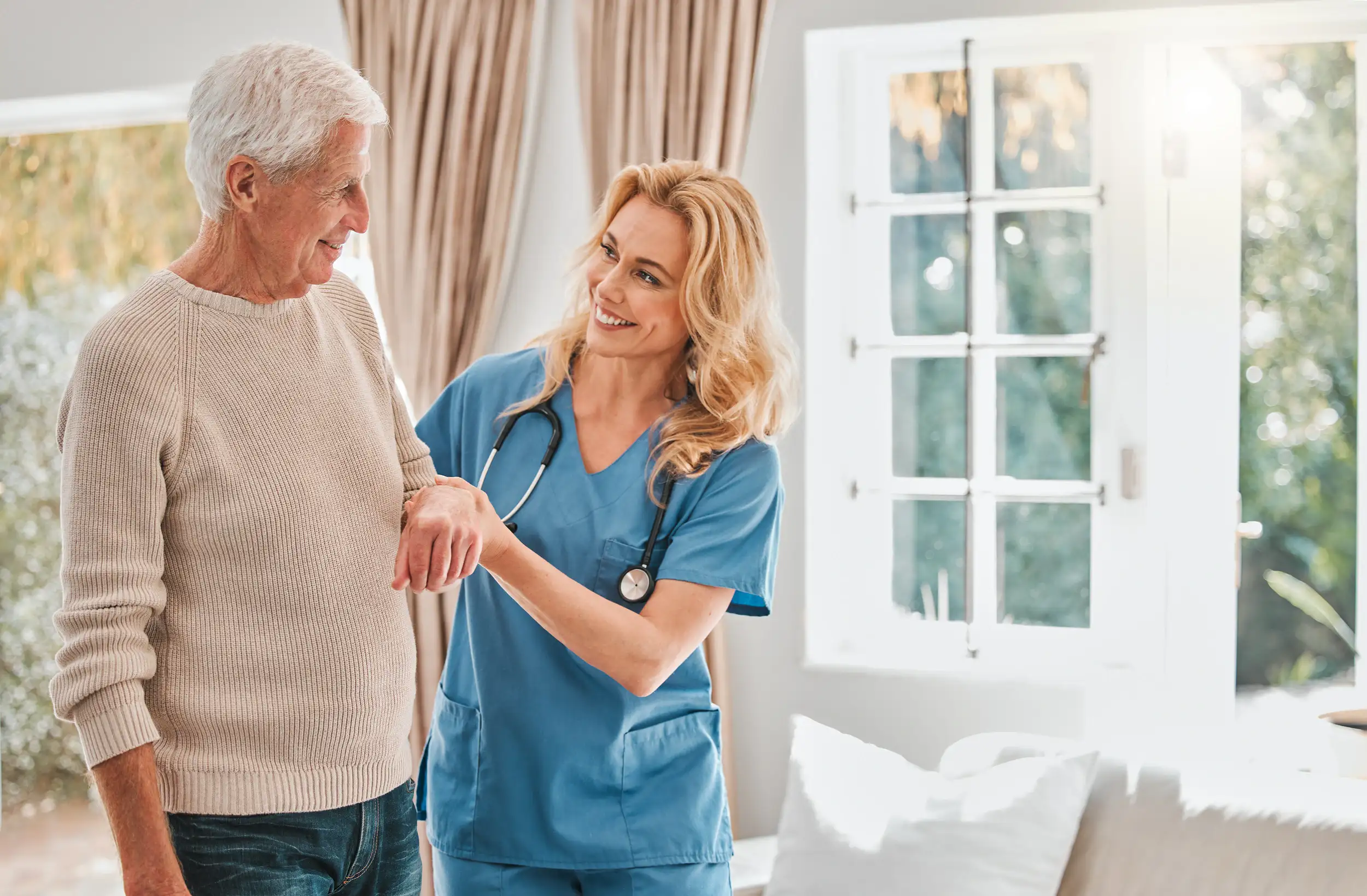 A nurse assisting an old man to his room.
